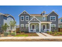 Charming paired home featuring two-story design, stone accents, and inviting front porch at 15242 Detroit St, Thornton, CO 80602