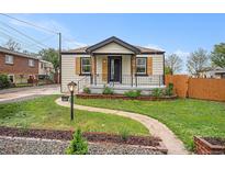 Charming single-story home with landscaped front yard, walkway, and welcoming porch at 5491 Lowell Blvd, Denver, CO 80221