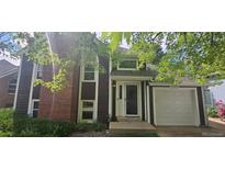 Charming home with a brick and wood facade, complemented by a well-maintained lawn and an attached one-car garage at 16724 E Hialeah Ave, Centennial, CO 80015