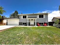 Charming home featuring a well-manicured lawn, two-car garage and relaxing front porch at 8820 Cody St, Broomfield, CO 80021