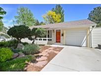 Charming one-story home with a well-manicured front yard and a welcoming red front door at 1370 S Hudson St, Denver, CO 80222