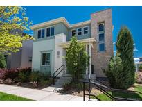 Charming two-story home with stone accents, manicured landscaping, and a welcoming front porch at 9781 Dunning Cir, Highlands Ranch, CO 80129