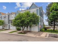 Charming townhouse with a well-maintained lawn, mature tree and attached garage, creating an inviting curb appeal at 1699 S Trenton St # 174, Denver, CO 80231