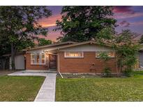 Charming single-story brick home with a well-maintained lawn and a tidy sidewalk leading to the front door at 400 W Midway Blvd, Broomfield, CO 80020