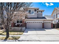 Charming two-story home with a three-car garage and inviting front porch at 16240 E 119Th Ave, Commerce City, CO 80022