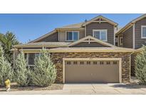 Charming two-story home with stone accents, a two-car garage, manicured landscaping and beautiful curb appeal at 14923 E Crestridge Dr, Centennial, CO 80015