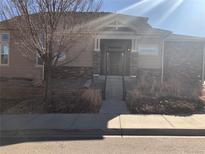 Charming single-story home with a landscaped front yard and welcoming entrance, perfect for a cozy and inviting atmosphere at 14923 E Crestridge Dr, Centennial, CO 80015