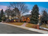 Charming single-Gathering home boasting mature trees, brick accents, and a well-manicured lawn at 15895 W Bayaud Dr, Golden, CO 80401