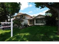 Charming two-story home with a manicured lawn and mature trees, presenting a welcoming curb appeal at 9910 Winona St, Westminster, CO 80031