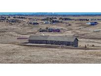 Expansive single-story home with a three-car garage and carport nestled on a sprawling lot with mountain views at 46120 County Road 17, Elizabeth, CO 80107