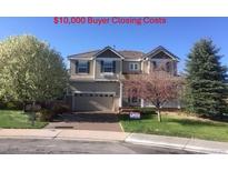 Charming two-story home with a two-car garage and mature trees in the front yard at 3480 Spruce Dell Ct, Castle Rock, CO 80109
