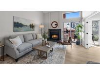Inviting living room with a cozy fireplace and lots of natural light at 4899 S Dudley St # 19, Littleton, CO 80123