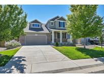 Charming two-story home with inviting front porch, landscaped front yard, and a two car garage at 4037 S Odessa Cir, Aurora, CO 80013