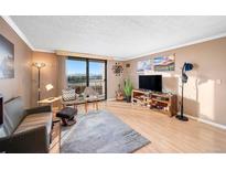 Cozy living room with large windows offering great views and a comfortable seating arrangement at 1301 Speer Blvd # 410, Denver, CO 80204