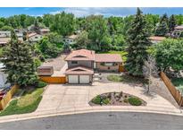 Aerial view of a two-story house with a spacious driveway and a well-maintained, lush green yard at 2380 W 105Th Pl, Northglenn, CO 80234