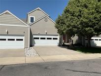 Charming home featuring a two-car garage, mature landscaping, and a well-maintained yard on a sunny day at 15555 E 40Th Ave # 11, Denver, CO 80239