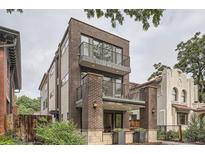 Stunning brick townhouse featuring multi-level balconies and contemporary design elements at 1895 York St, Denver, CO 80206