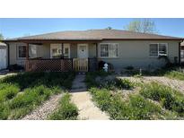 Charming single-story home with a covered porch and mature landscaping at 1151 Revere St, Aurora, CO 80011