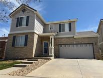 Beautiful two-story home with neutral brick, gray siding, and updated landscaping at 1160 S Fultondale Ct, Aurora, CO 80018