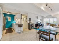 Bright living space featuring a bar, dining area, and kitchen with modern appliances and ample natural light at 1255 N Ogden St # 605, Denver, CO 80218