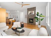 Bright living room features a fireplace, hardwood floors, and stylish contemporary furnishings at 340 S Lafayette St # 201, Denver, CO 80209