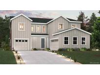 Charming two-story home featuring a two-car garage, a well-manicured lawn, and beautiful landscaping at 1699 Morgan Dr, Erie, CO 80516