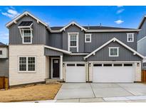 Charming two-story home featuring a 2-car garage and stone and vinyl siding at 9322 Quaker St, Arvada, CO 80007