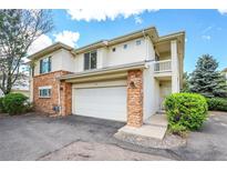 Inviting two-story home with a two-car garage and brick accents, perfect for comfortable living at 1311 S Kingston St, Aurora, CO 80012