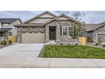 Charming single-Gathering home featuring a stone facade and a two-car garage with modern doors at 15376 Ivanhoe Ct, Thornton, CO 80602