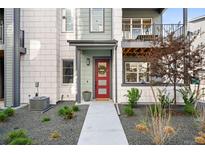 Charming front entrance with a red door, wreath, and well-maintained landscaping at 6792 Navajo Way, Denver, CO 80221