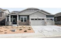 Charming single-story home with a stone facade, two-car garage, and well-maintained landscaping at 3877 Treadway Pt, Castle Rock, CO 80108