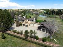 Majestic aerial shot of the estate, highlighting the beautifully landscaped grounds, multiple garages, and long private driveway at 50 Meade Ln, Cherry Hills Village, CO 80113