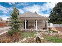 Charming bungalow with inviting front porch and whimsical landscaping at 7794 Louviers Blvd, Louviers, CO 80131