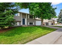 Charming two-story home with a well-maintained lawn and mature tree in a desirable neighborhood at 9196 W Maplewood Ave, Littleton, CO 80123