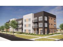 Modern apartment building featuring a mix of siding, brick, balconies, and large windows at 5702 N Central Park Blvd # 208, Denver, CO 80238