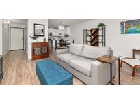 Bright living room showcasing an open floor plan, hardwood floors, and stylish decor, creating an inviting atmosphere at 6940 E Girard Ave # 210, Denver, CO 80224