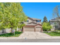 Charming two-story home with a three-car garage and well-manicured lawn, perfect for suburban living at 10062 Eagle Valley Way, Highlands Ranch, CO 80129