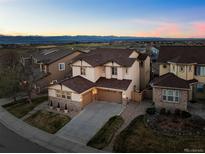 A captivating two-story home with a beautiful stone and siding exterior, plus a well-kept lawn at 2577 Shadecrest Pl, Highlands Ranch, CO 80126