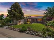 Charming single-Gathering home with a well-manicured lawn and mature trees at sunset at 1982 S Truckee St, Aurora, CO 80013