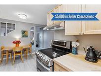 Charming kitchen featuring stainless steel appliances, light wood cabinets, and a cozy breakfast nook at 1111 Maxwell Ave # 228, Boulder, CO 80304