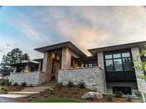 Stunning exterior view of modern stone home with manicured landscaping at 5429 S Kearney St, Greenwood Village, CO 80111