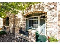 Charming stone archway and decorative details enhance this inviting townhome entrance at 452 Black Feather Loop # 608, Castle Rock, CO 80104