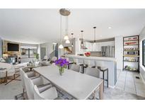 Bright living room featuring an open floor plan that connects to a modern kitchen with stainless steel appliances at 8755 W Cornell Ave # 14-5, Lakewood, CO 80227