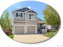 Charming two-story home with a two-car garage and well-manicured lawn at 9687 Timbervale Ct, Highlands Ranch, CO 80129