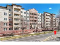 Modern apartment building exterior featuring balconies, brick accents, and a well-maintained landscape at 2200 S University Blvd # 105, Denver, CO 80210