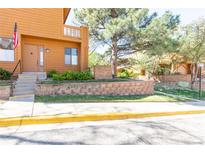 Inviting home exterior with a well-manicured lawn, mature trees, and a warm, neutral color palette at 9400 E Iliff Ave # 411, Denver, CO 80231