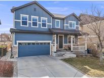 Charming two-story home with a well-manicured lawn and a two-car garage at 10294 E Telluride Ct, Commerce City, CO 80022