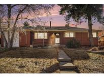 Brick ranch house with a landscaped yard and walkway at 8550 E Davies Pl, Centennial, CO 80112