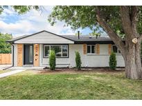 Charming, newly renovated single-story home with modern wood and painted brick exterior at 530 Everett St, Lakewood, CO 80226
