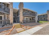 Attractive condo exterior with two-story design, stone accents, and inviting stairwell at 3480 S Eagle St # 101, Aurora, CO 80014